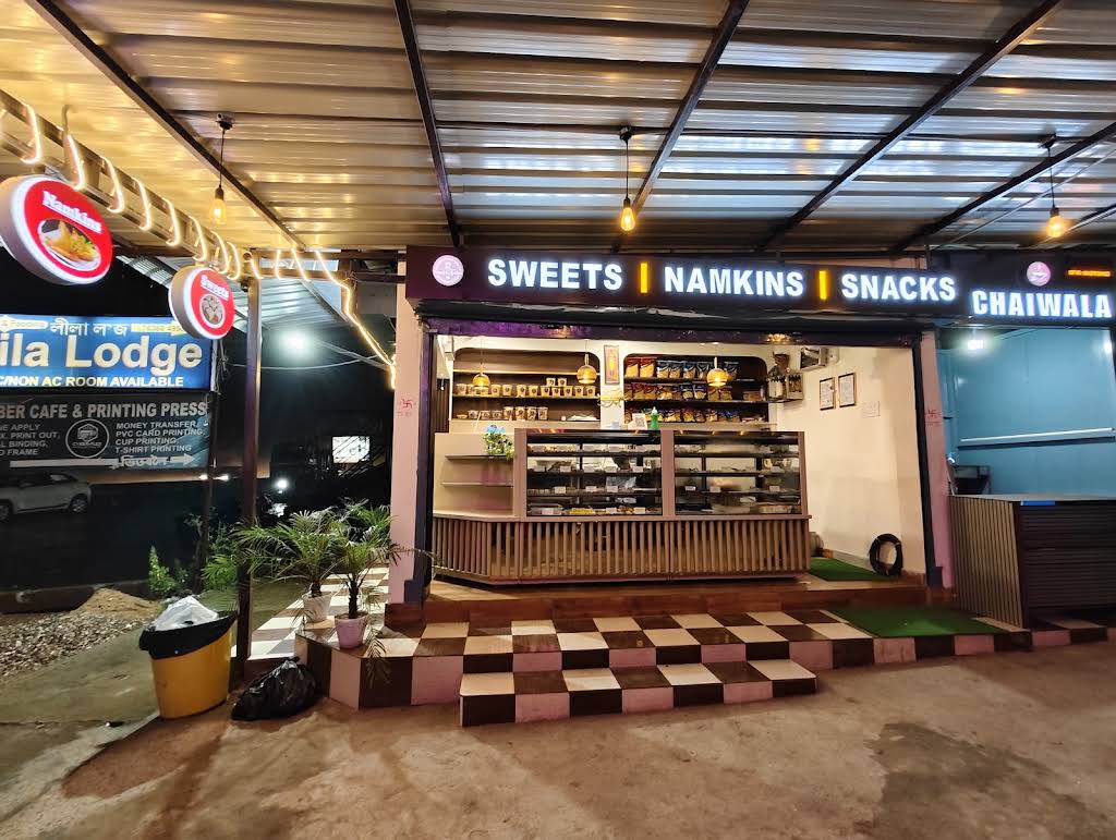 The warmly lit entrance and sweets counter at Nand Gopalaa